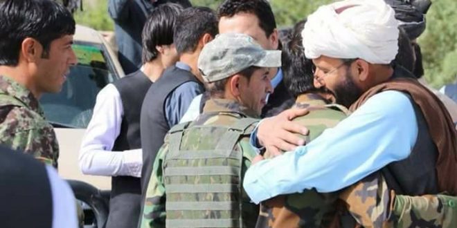 Taliban fighters embrace afghan security forces