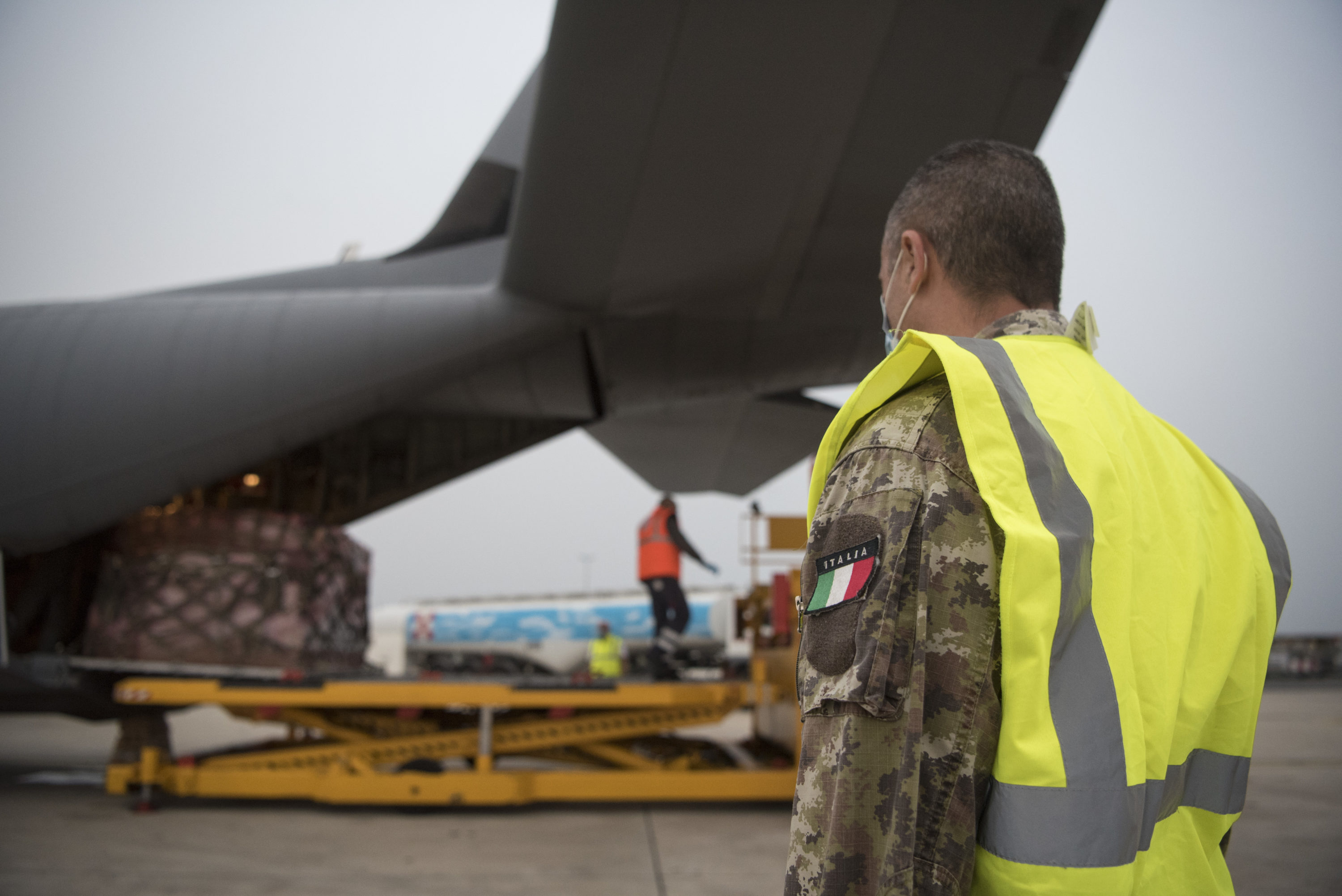An Italian air force member stands-by as a pallet of medical supplies from Milan, Italy is off-loaded from an 86th Airlift Wing C-130J Super Hercules in Rome (U.S. Air Force photo by Senior Airman Kristof J. Rixmann)